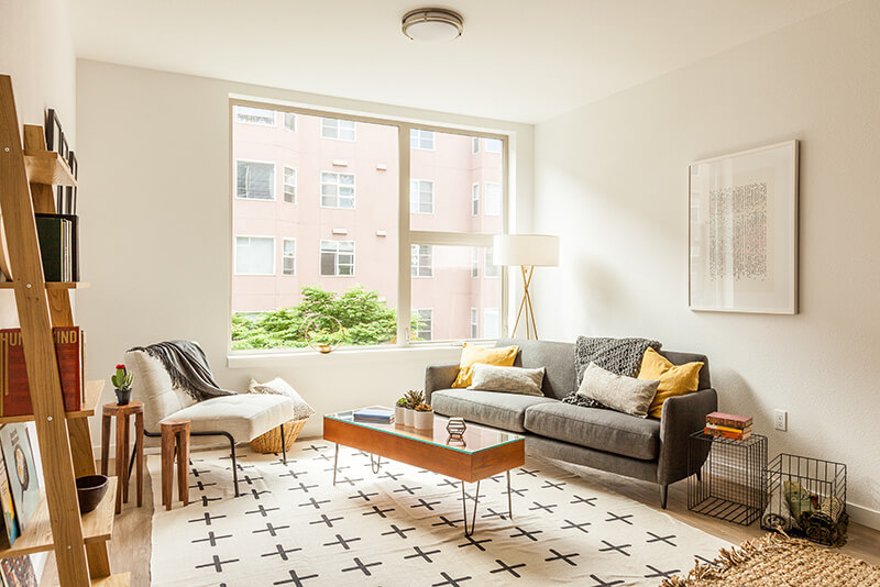 Bright cozy living room with window in an apartment for rent in Troy MI